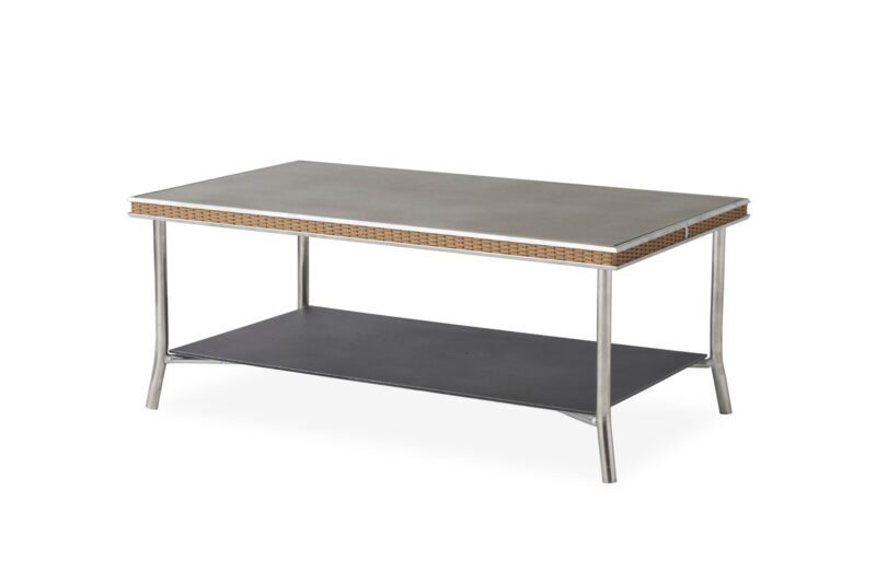 A modern coffee table with a sleek gray top, a rattan edge, and a lower shelf, set against a plain white background.