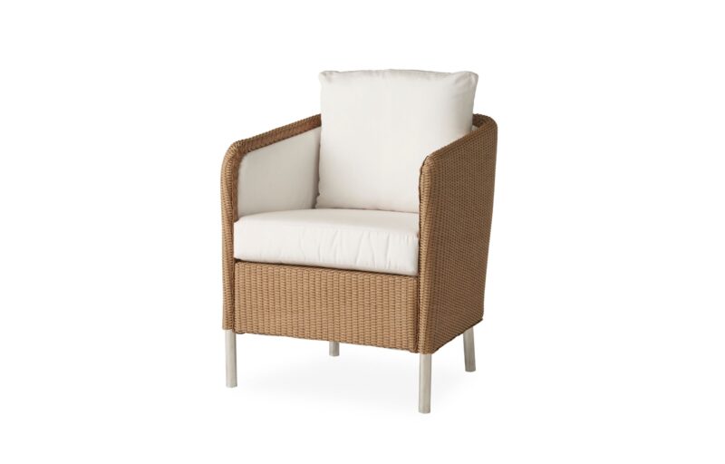 A modern rattan armchair with a sturdy white metal frame, featuring thick white cushions on the seat and back, isolated on a white background.