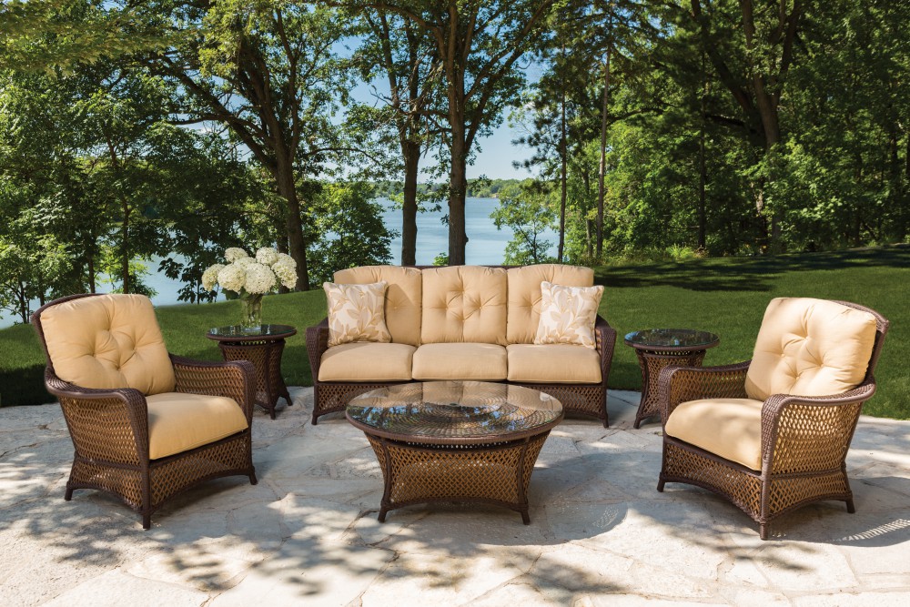 Wicker patio set by Lloyd Flanders from the Grand Traverse Collection with beige cushioning