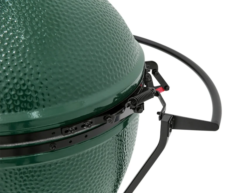 Close-up view of the lid, handle, and hinge of the Large Big Green Egg, showing detailed texture and metallic components.