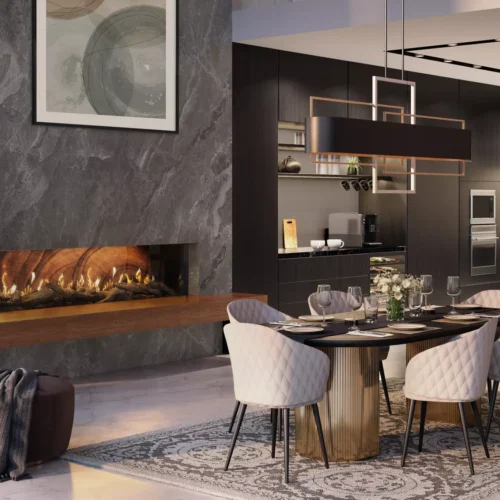 A modern dining room featuring a large wooden table set for dinner, flanked by six white chairs on a gray patterned rug, with a stylish kitchen in the background and an Enlight Corner Gas Fireplace by