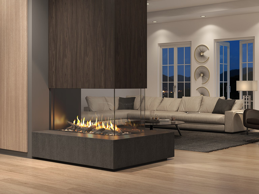A modern living room at night with a large glass-encased fireplace, sectional sofa, sleek decor, and cityscape visible through floor-to-ceiling windows.