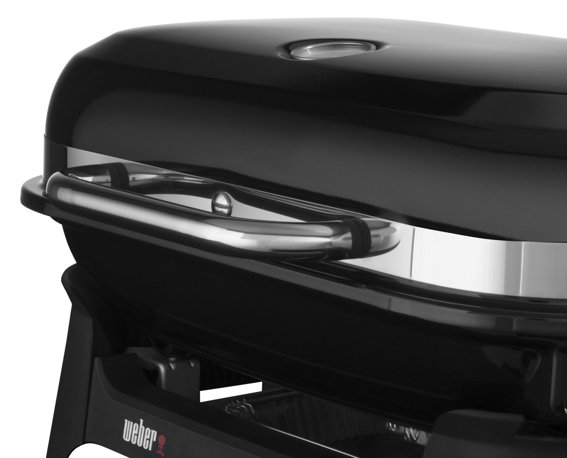 Close-up of a black weber grill showing the lid, handle, and part of the grill body with the brand's logo visible.