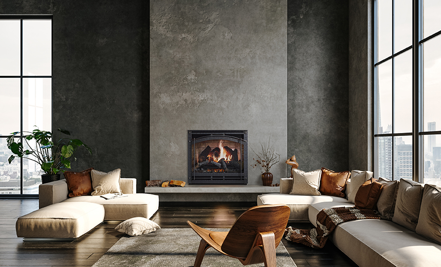 Modern living room with large windows, a sectional sofa with beige cushions, a wooden chair, and a SimpliFire Inception Electric Fireplace on a textured gray wall. A potted plant adds a touch