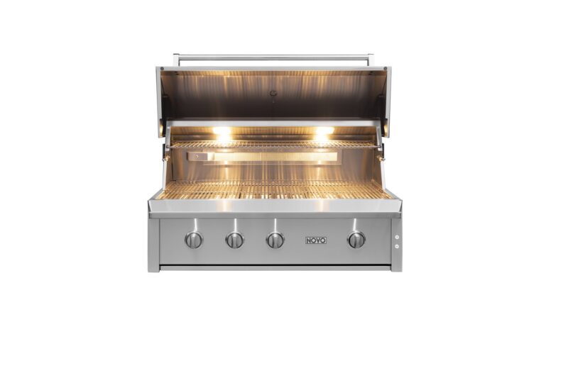 A stainless steel outdoor grill with the lid open, revealing a clean, shiny interior with twin burners and cooking grates, and illuminated by in-built lights.
