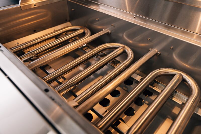 Interior of a clean oven showcasing shiny twin metal heating elements and grates.