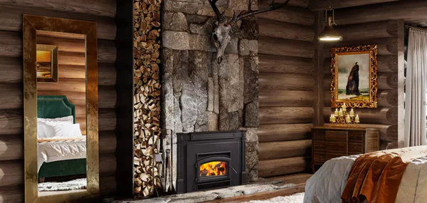 Cozy rustic cabin interior featuring a stone fireplace with a mounted deer head, wood-paneled walls, and a glimpse into a bedroom through a mirrored door.