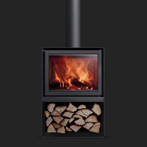A modern freestanding fireplace with a visible fire behind a glass door, featuring a compartment below stacked with firewood, against a dark background.