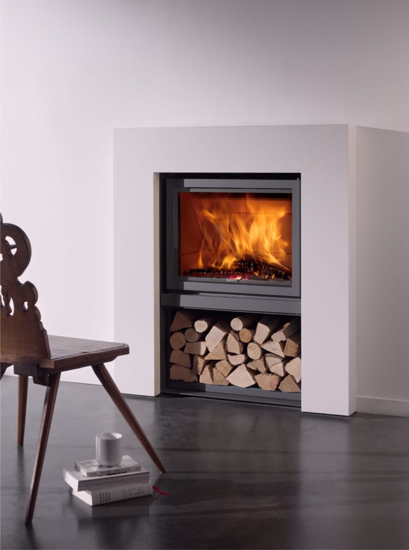 A modern fireplace with logs and a chair.